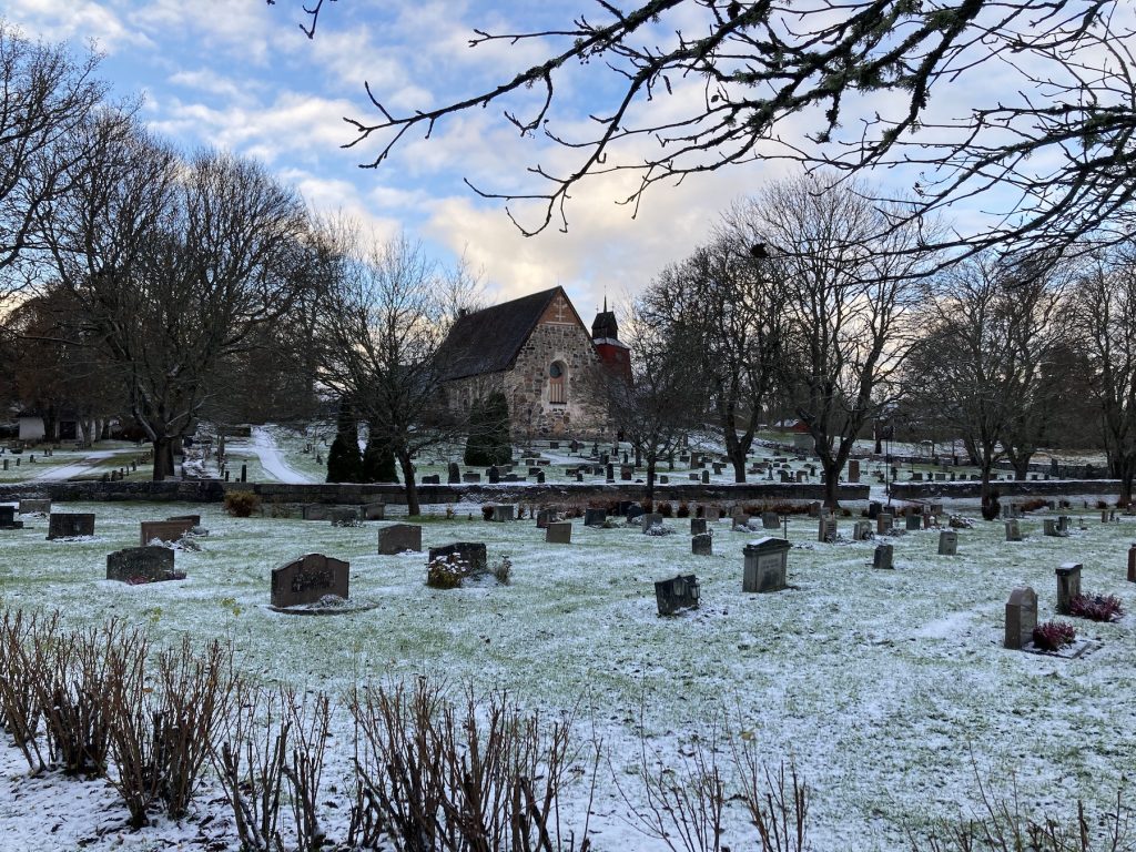 Graveyard with old church on a winterday